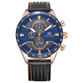 A men's chronograph watch with a blue dial, rose gold-tone case, and a black perforated leather strap with orange stitching, shown on a plain white background.